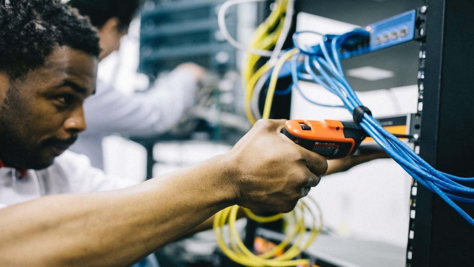 Technician working on server cables.