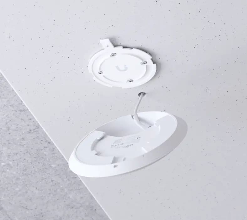 Ceiling smoke detector with open cover.
