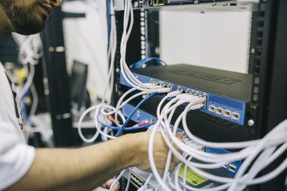 Technician working on server cables connection.