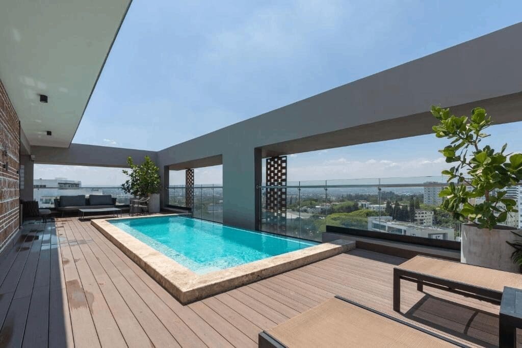 Rooftop pool with cityscape view.