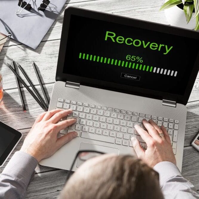 A man working to recover his data after his computer crashed.
