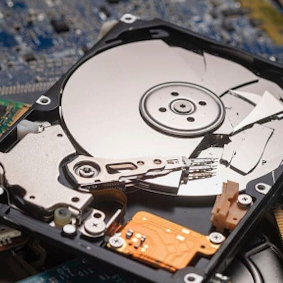 A computer hard drive is shown with its disc.