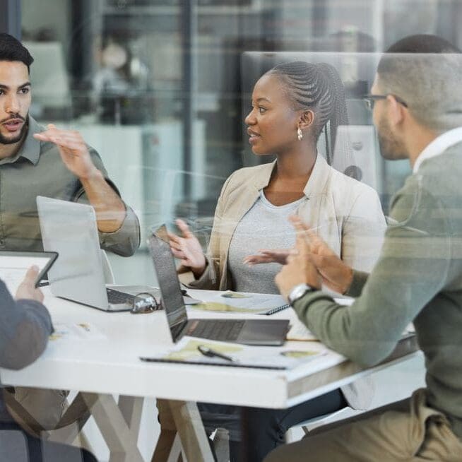 A large company using their updated laptops during a business meeting.